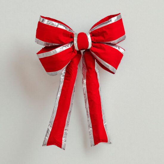 A classic Christmas bow featuring rich red material tied in a symmetrical shape, accented by a striking silver trim.