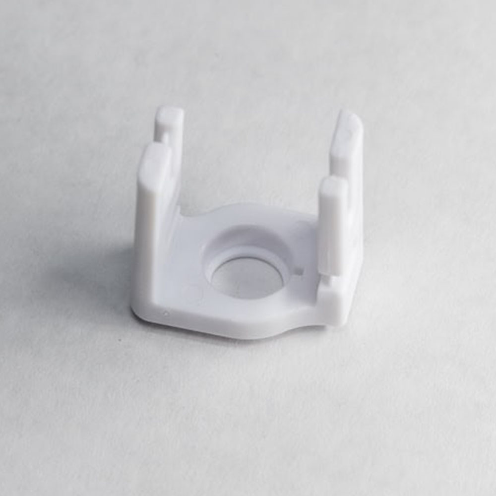 Close-up of a square LED strip light mounting clip, designed to secure a flexible light strip and allow for screw attachment.