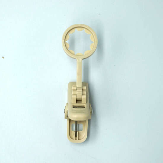 A single, cream-colored plastic clip hanger accessory, commonly used for securing lights or decorations, on a light blue-gray background.