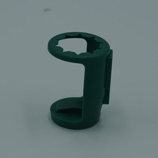 A small, green accessory clip designed for decorative lighting, with a circular, toothed slot for securing a bulb or cord.