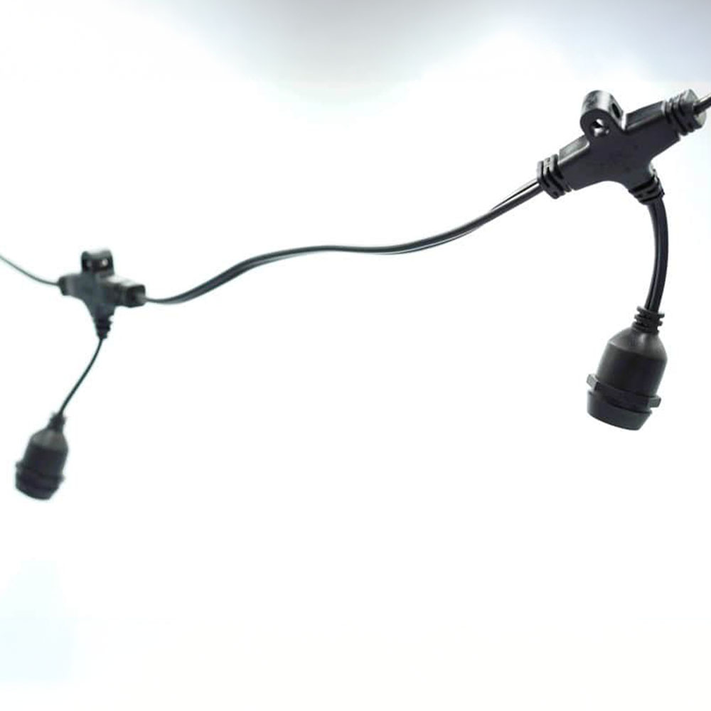 A segment of professional-grade festoon lighting highlighting the wiring method. The setup uses a parallel wiring scheme where the socket drop is integrated via a sealed T-connector.