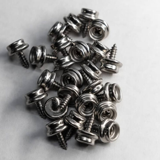 A pile of shiny chrome or nickel-plated snap fastener studs with integrated screw threads for permanent mounting.