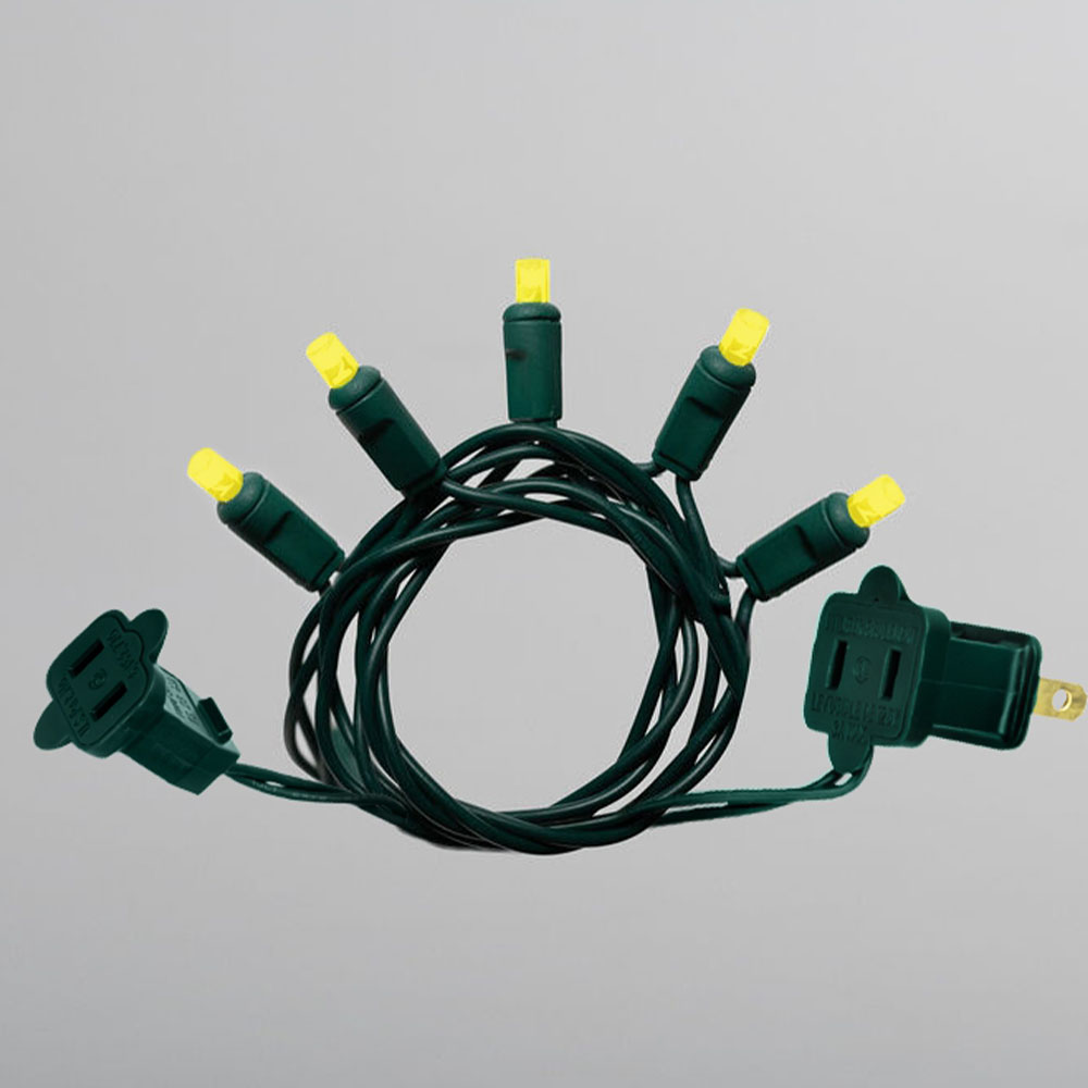 A small, coiled section of yellow LED mini-string lights with green wire and both the male and female connector plugs visible.
