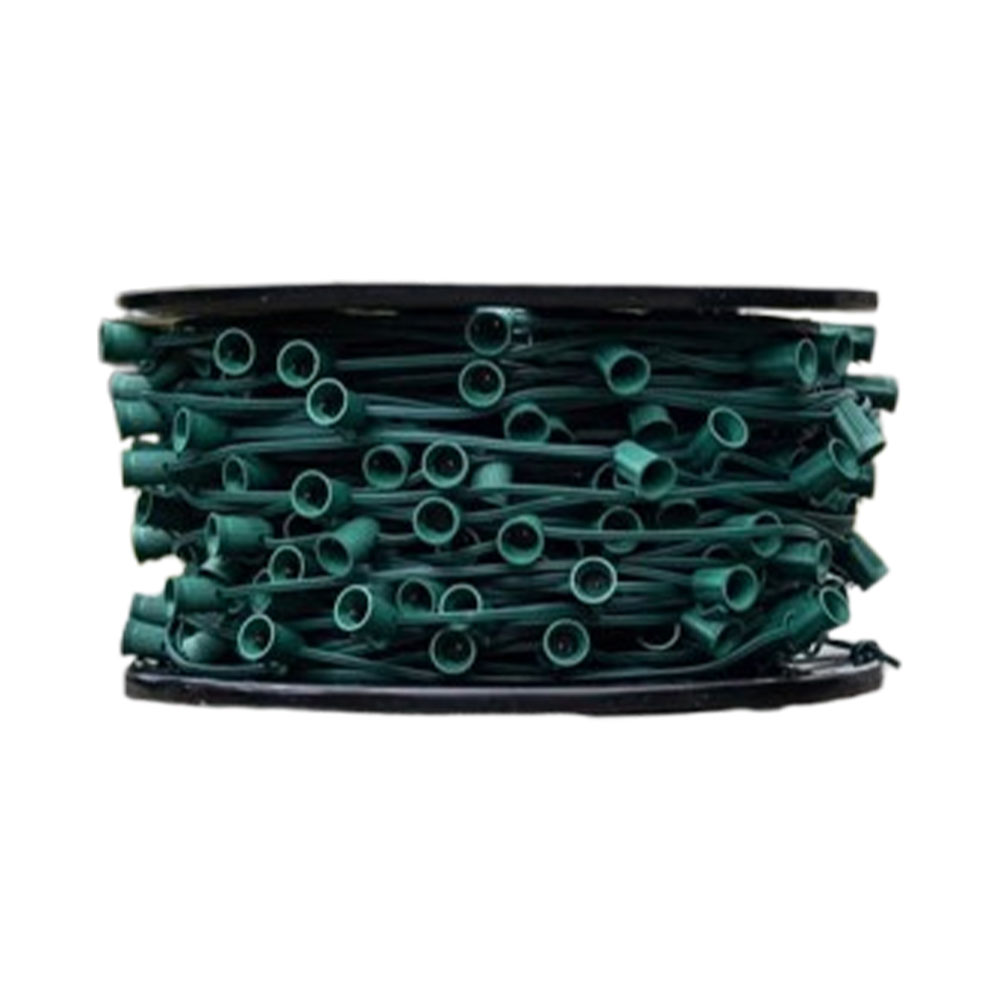 Closeup of a black reel packed tightly with bulk green wire and numerous snap-in or screw-in empty light bulb holders